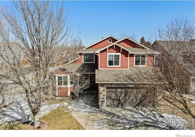 view of front of property featuring a garage, stone siding, a shingled roof, and concrete driveway