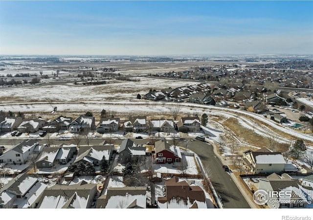 snowy aerial view with a residential view