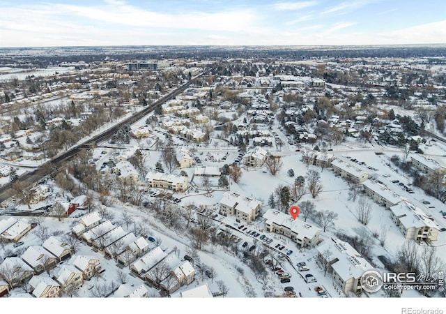 snowy aerial view with a residential view