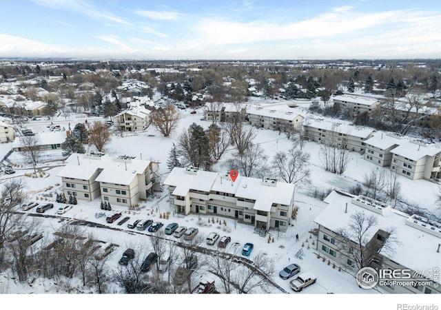 snowy aerial view with a residential view