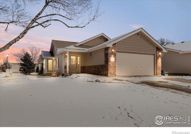 view of front of house with an attached garage and brick siding