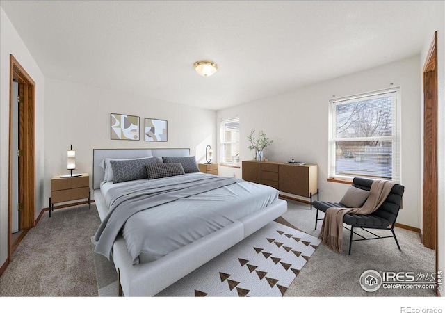 bedroom featuring baseboards and light colored carpet