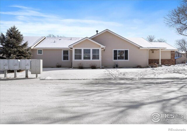 view of snow covered rear of property