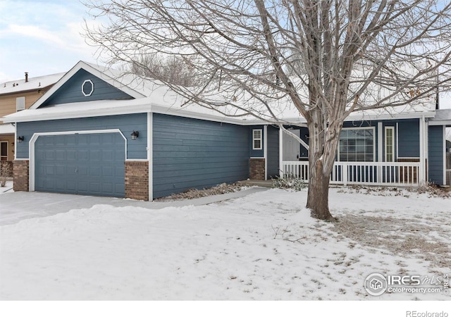 view of front of property featuring covered porch, brick siding, and an attached garage