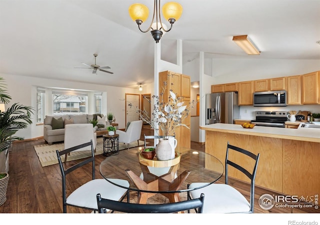 dining space with high vaulted ceiling, dark wood-style flooring, and ceiling fan with notable chandelier