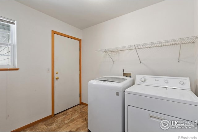 laundry area with laundry area, baseboards, and separate washer and dryer