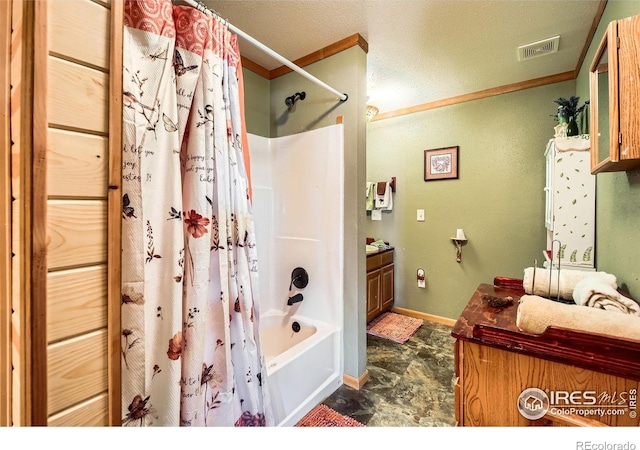 full bath with shower / tub combo, baseboards, stone finish floor, ornamental molding, and vanity