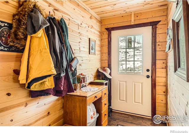 entryway with dark wood-style floors, wood walls, and wood ceiling