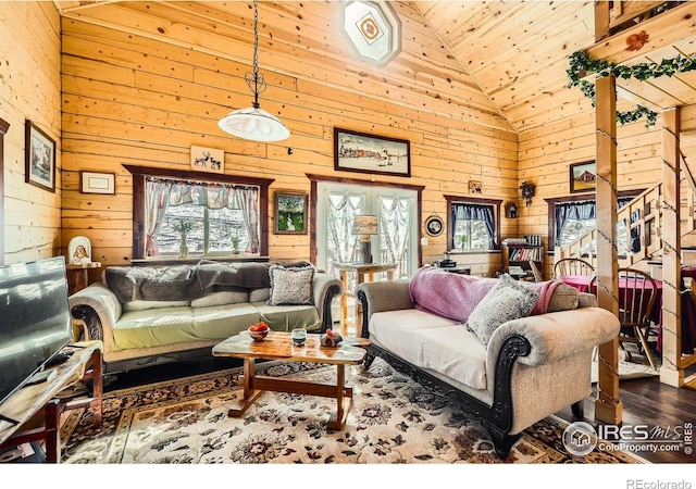 living room with dark wood-type flooring, high vaulted ceiling, and wooden walls