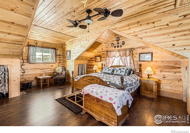 bedroom with multiple windows, dark wood finished floors, and wooden walls