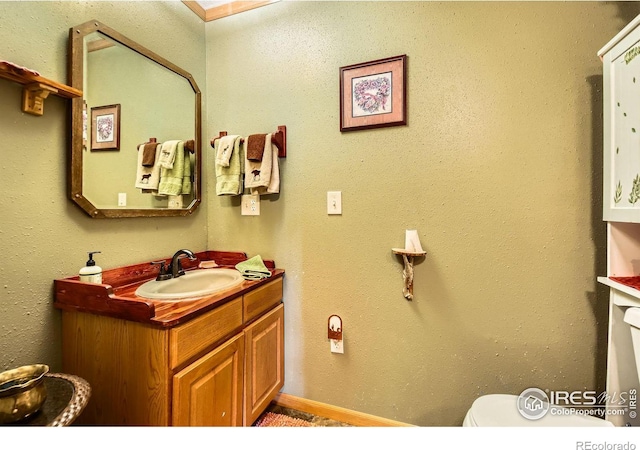 bathroom with toilet and vanity