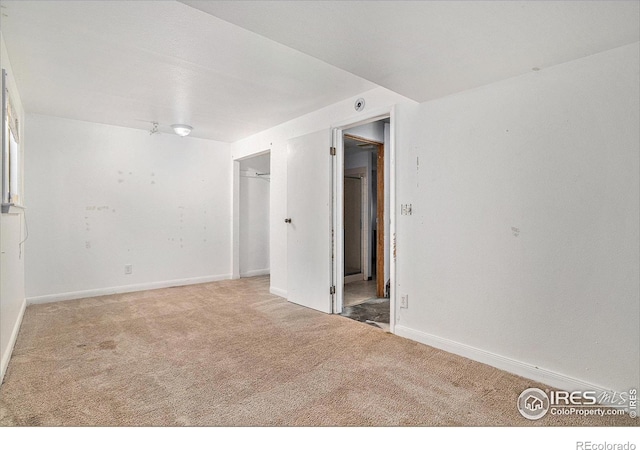 empty room with carpet and baseboards