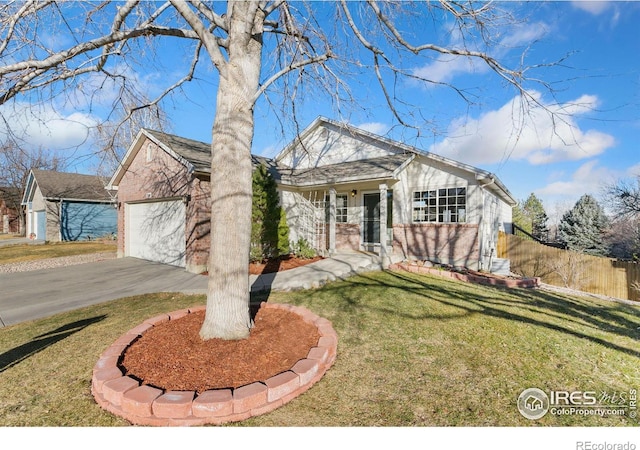 view of front of home with aphalt driveway, a garage, brick siding, fence, and a front lawn