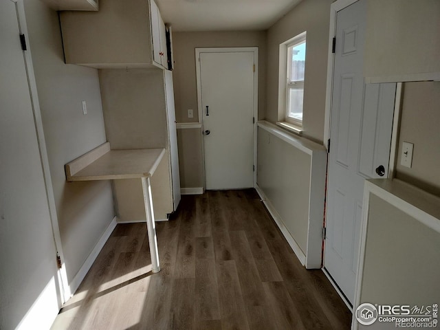 interior space with wood finished floors and baseboards