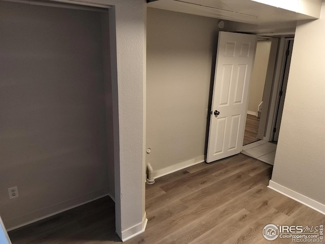 unfurnished bedroom featuring wood finished floors and baseboards