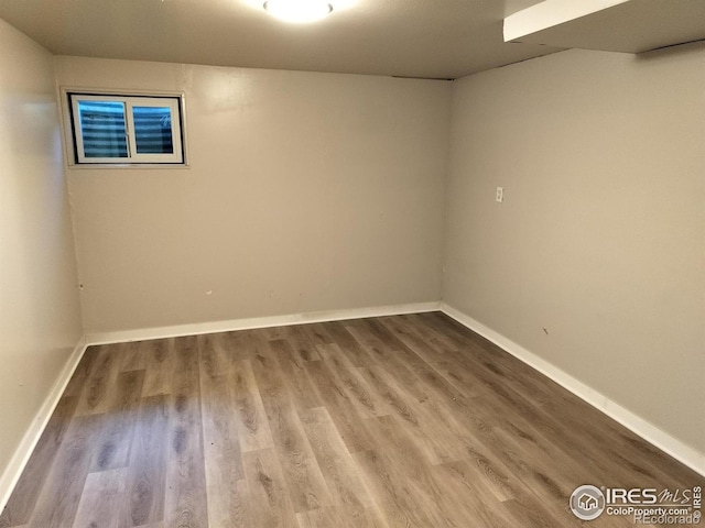 unfurnished room featuring wood finished floors and baseboards