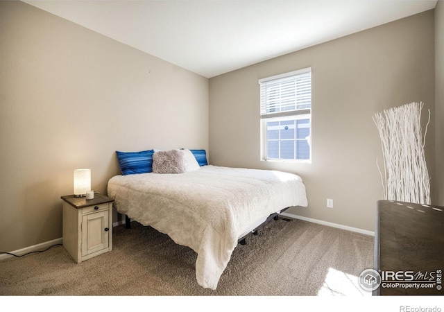 bedroom featuring light carpet and baseboards