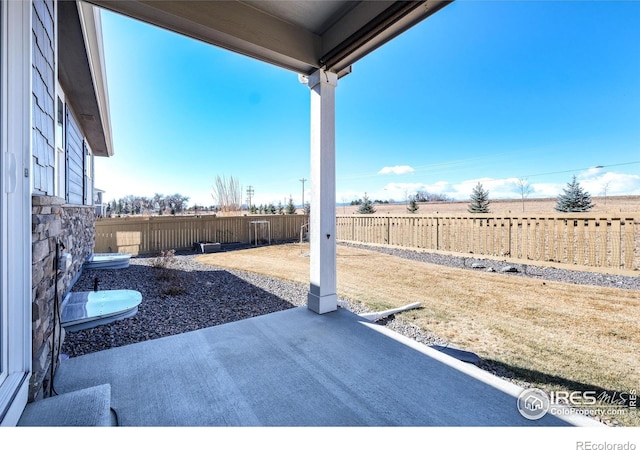 view of patio / terrace with a rural view and a fenced backyard