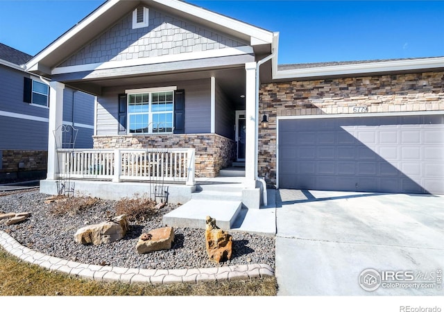 view of front of home with covered porch, concrete driveway, stone siding, and an attached garage