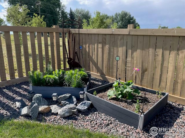 view of yard with a vegetable garden and fence