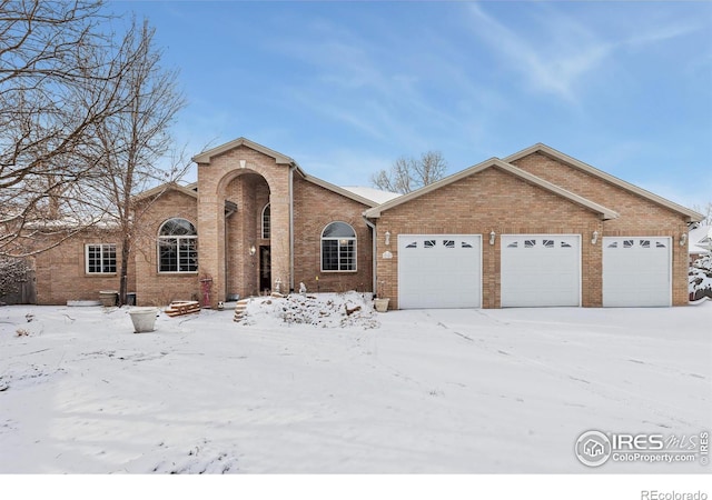 view of front of home with a garage and brick siding