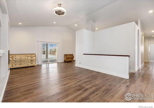 unfurnished room with dark wood-style floors, vaulted ceiling, and recessed lighting