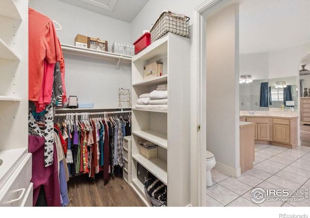 walk in closet with light tile patterned floors