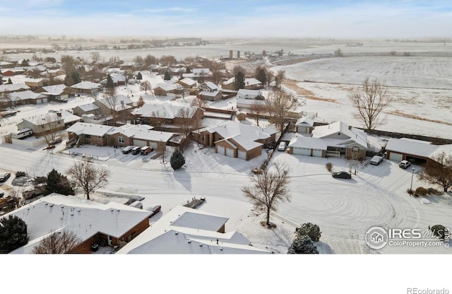 snowy aerial view featuring a residential view