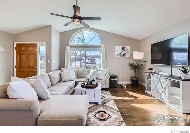 living room featuring dark wood-style floors, lofted ceiling, baseboards, and a ceiling fan