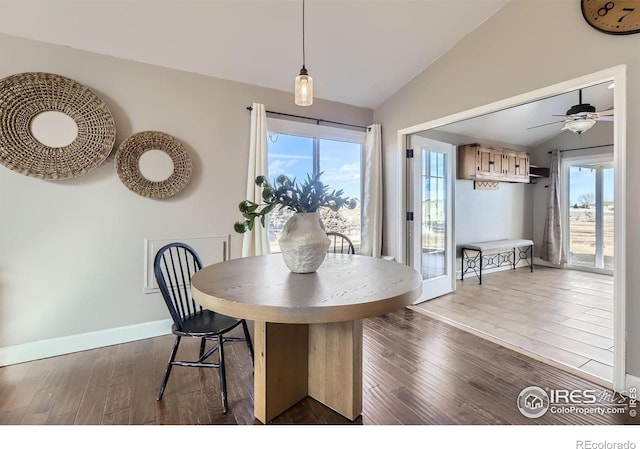 dining area featuring lofted ceiling, a wealth of natural light, baseboards, and dark wood-type flooring