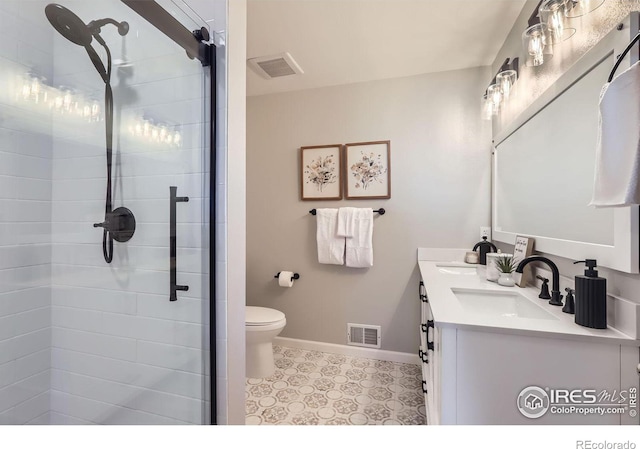 bathroom with baseboards, visible vents, and a sink