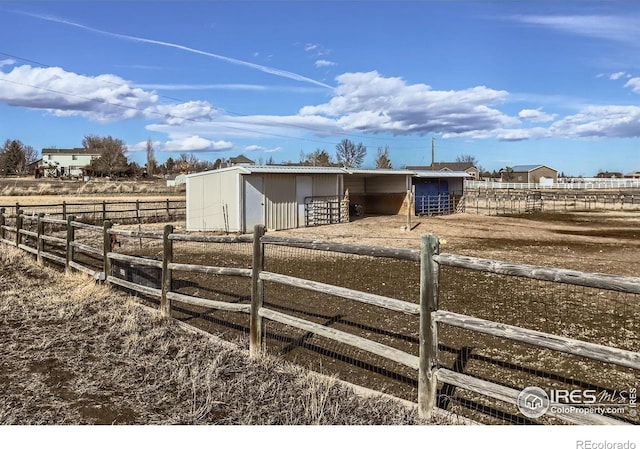 view of stable with a rural view