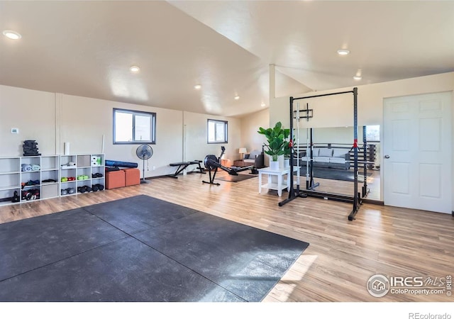 exercise room featuring wood finished floors and recessed lighting