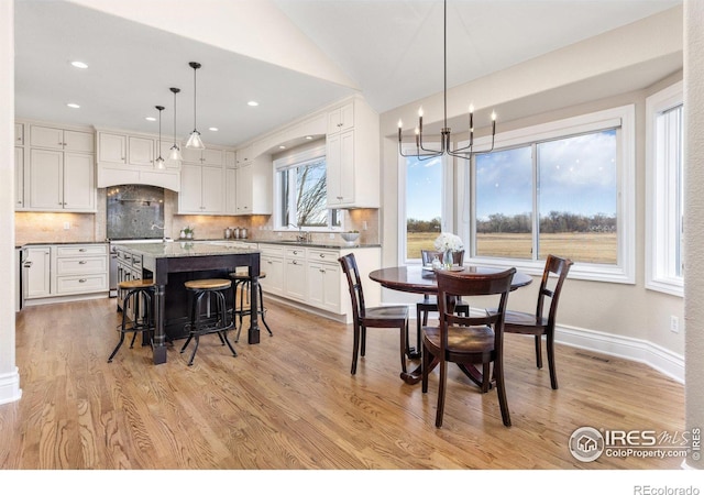 dining area with light wood-style floors, recessed lighting, a chandelier, and baseboards