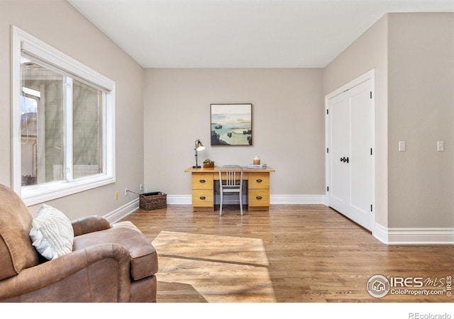 office featuring light wood-style flooring and baseboards