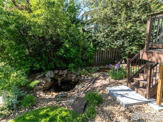 view of yard featuring stairs and fence