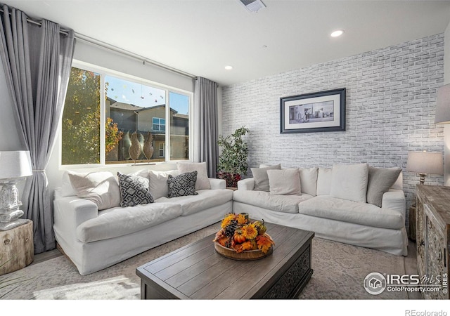 living room with brick wall and recessed lighting