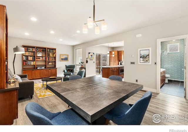 dining area with light wood-style flooring, baseboards, and recessed lighting