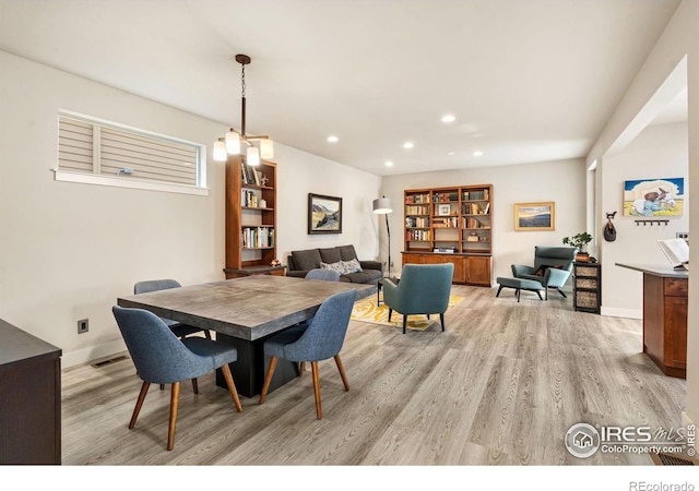 dining space with light wood-type flooring, baseboards, and recessed lighting