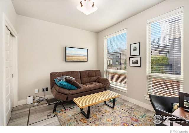 living room featuring light wood finished floors and baseboards