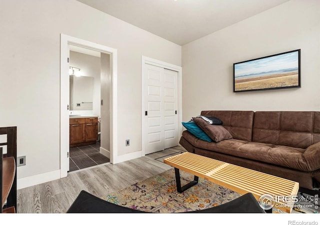 living room featuring wood finished floors and baseboards