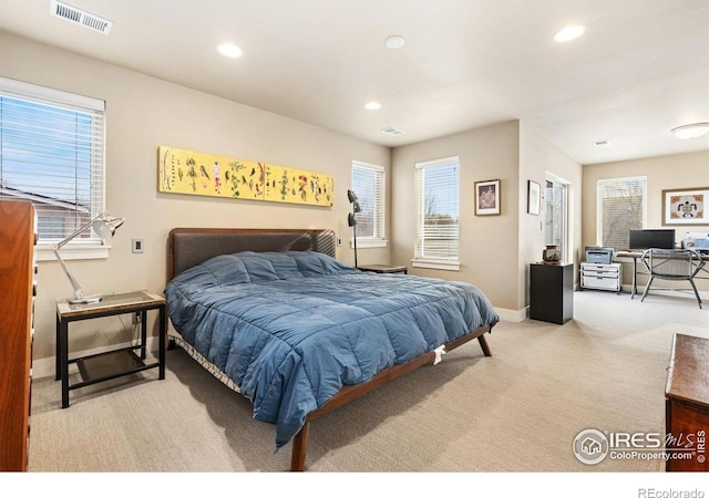 bedroom featuring light colored carpet, visible vents, baseboards, and recessed lighting