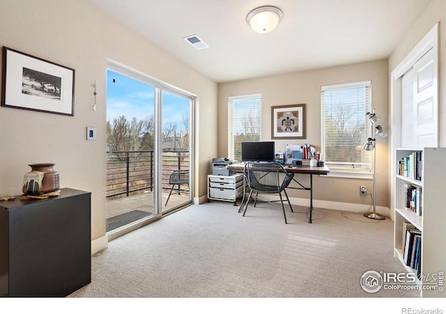 office area with light carpet, baseboards, and visible vents