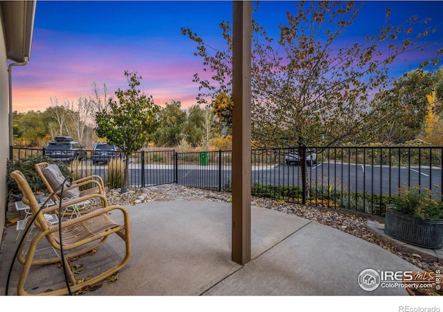 view of patio featuring a water view and a fenced backyard