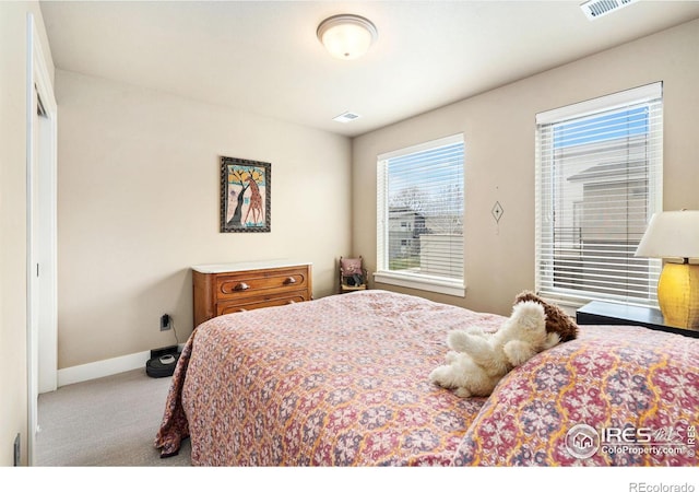 carpeted bedroom with baseboards