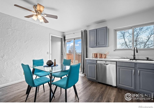 dining space with ceiling fan, baseboards, dark wood finished floors, and a textured wall