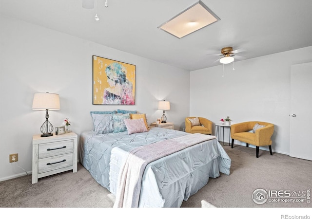 carpeted bedroom with a ceiling fan and baseboards