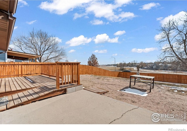 view of yard with a fenced backyard and a wooden deck