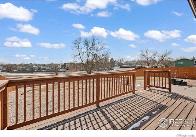 deck featuring fence and a residential view