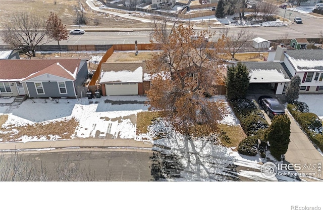 snowy aerial view with a residential view